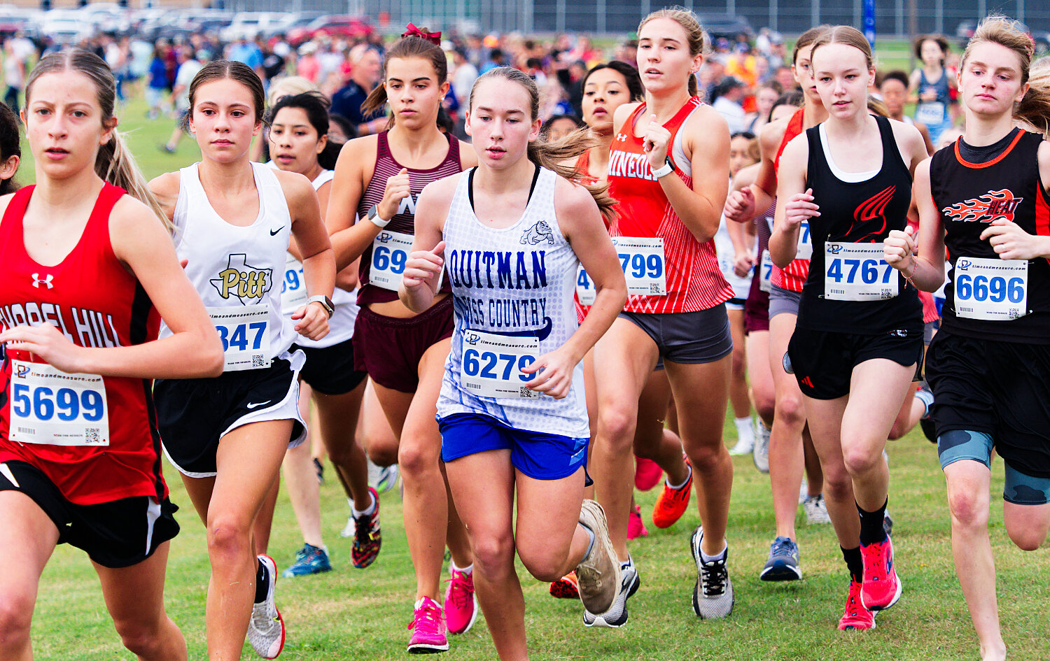 Braleigh Wood (center) of Quitman, trailed closely by Raylie Peebles of Mineola, get off to a quick start, eventually finishing first and sixth, respectively. [catch the cross-country competition]